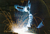 operator performing a welding of a curved tube